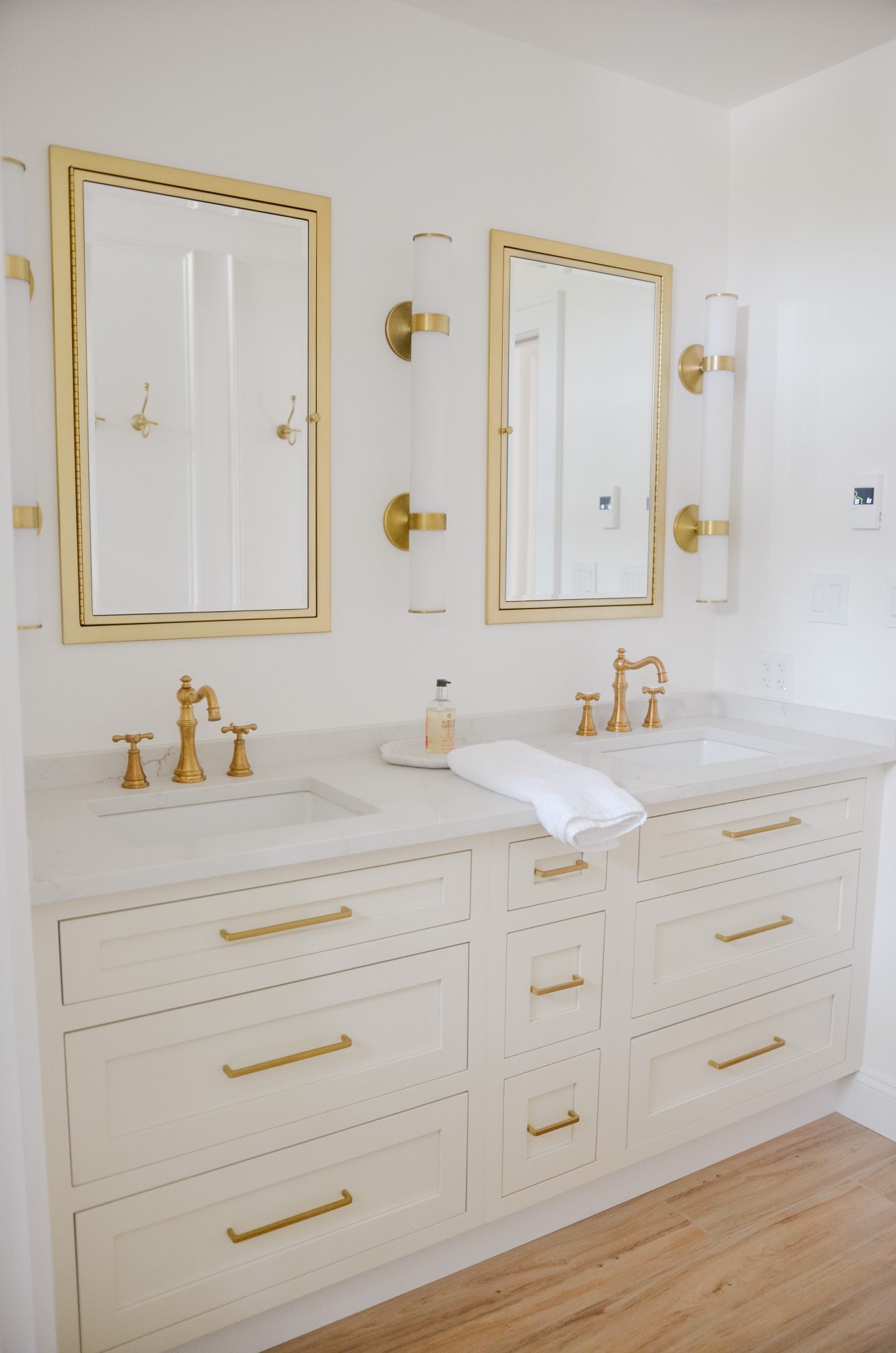 marble counters with gold mirrors in bathroom renovation