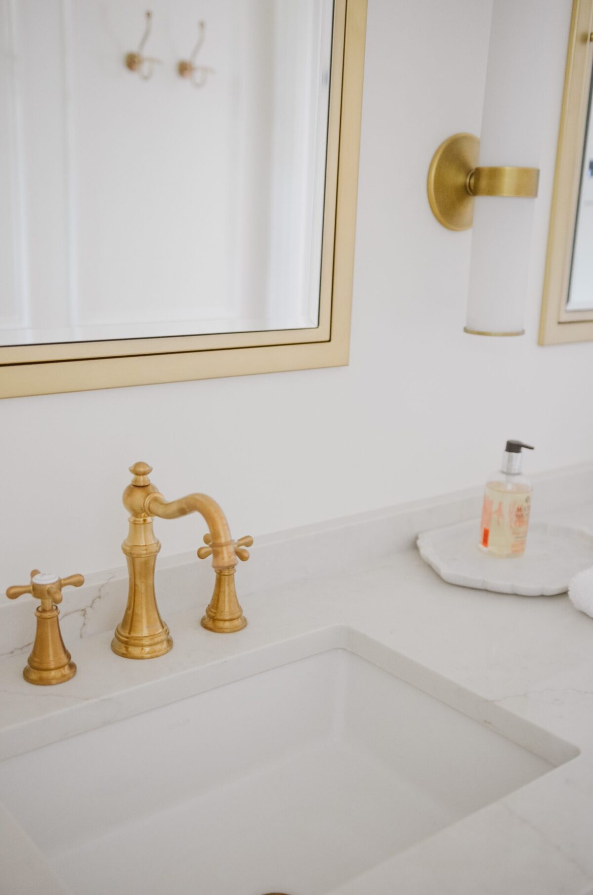 marble counters with gold mirrors in bathroom renovation