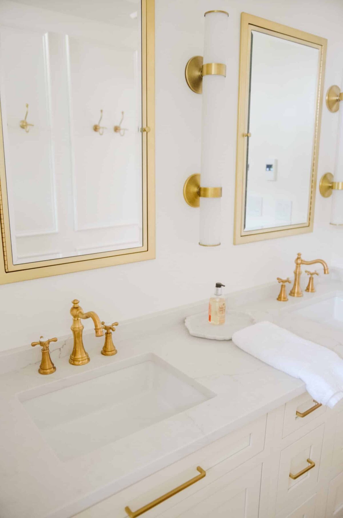 marble counters with gold mirrors in bathroom renovation