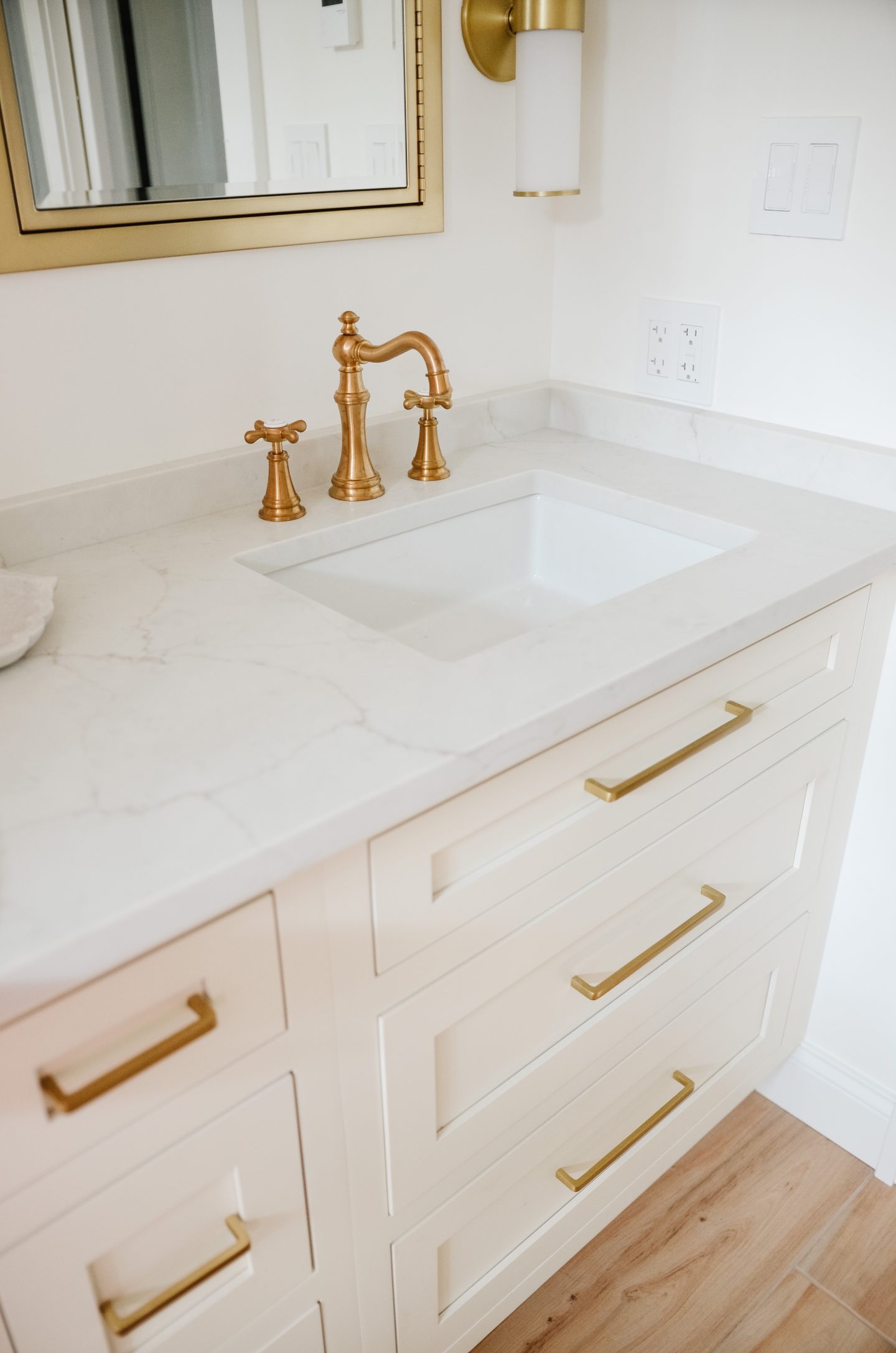 marble counters with gold hardware in bathroom renovation