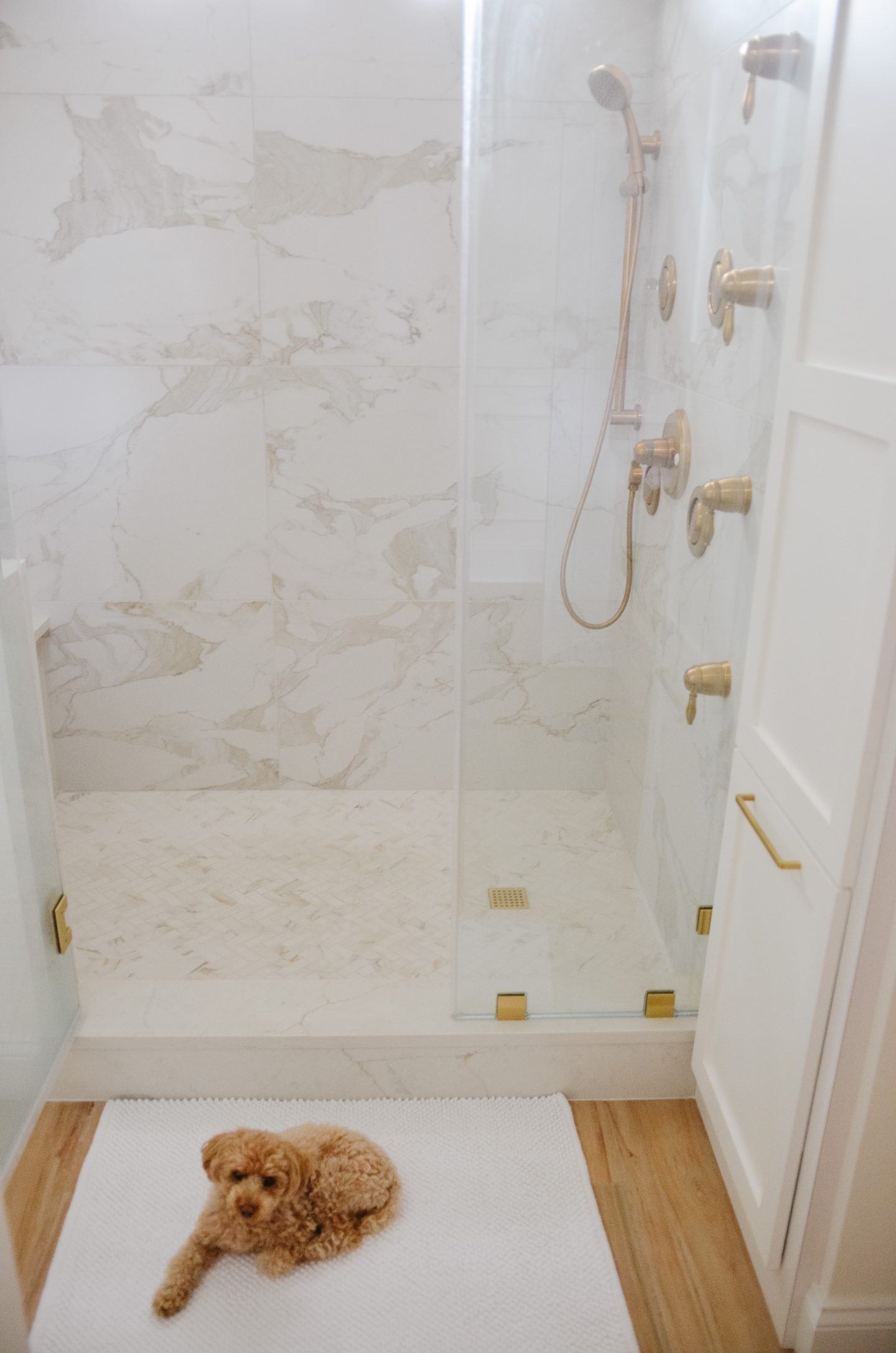 marble shower with gold in bathroom remodel before and after