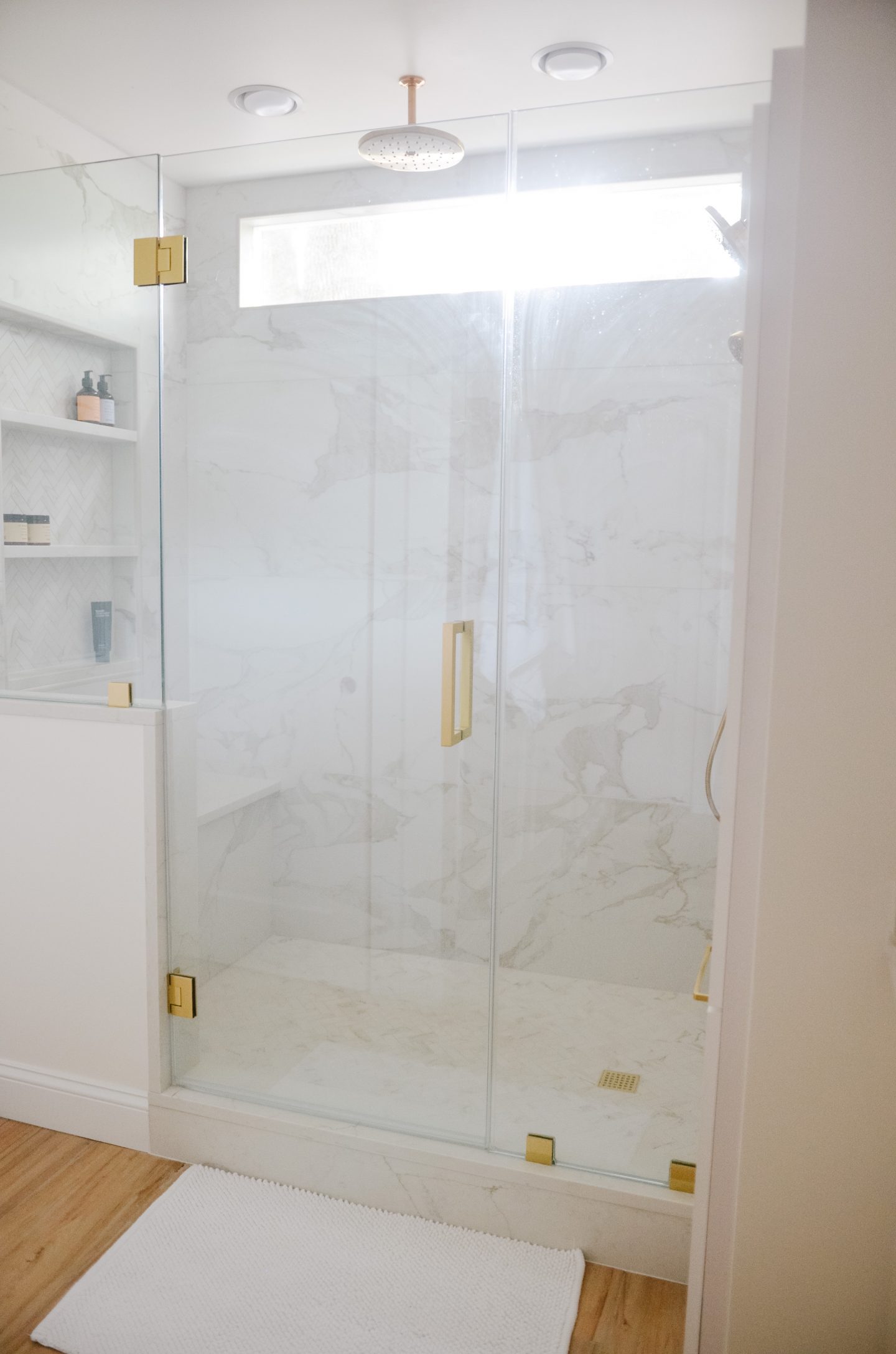 marble shower with gold in bathroom remodel before and after