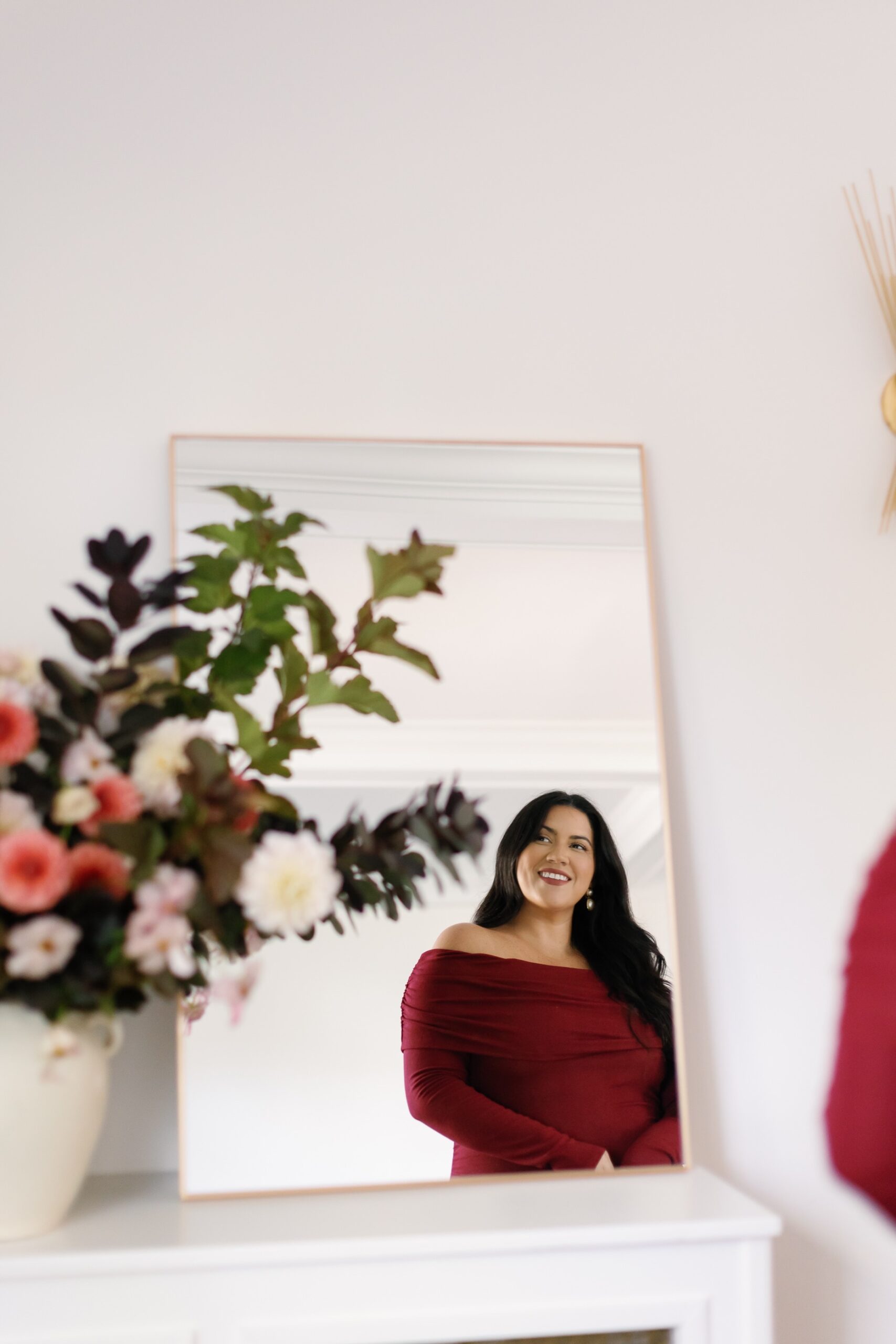 Burgundy holiday party outfits and winter flowers